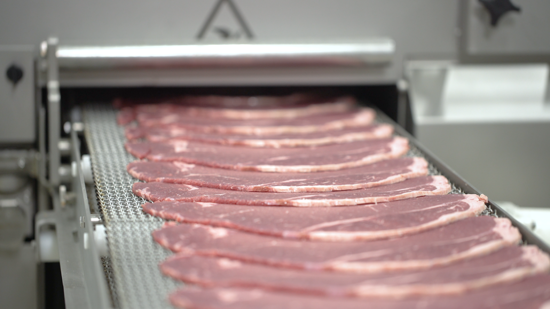 Sliced bacon on a Grote industrial Meat Slicer